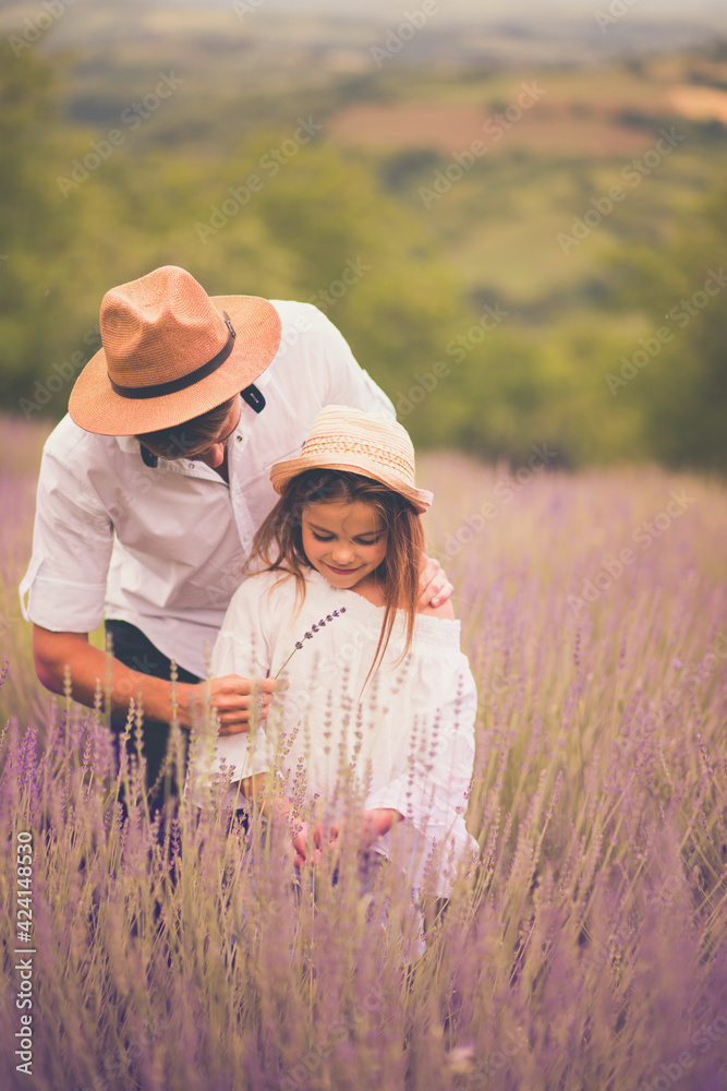 Father and daughter in a lavender field.