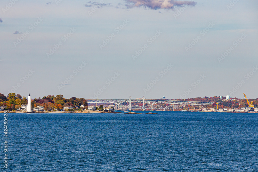 view to coast of New London  on a sunny day with lighthouse and bridge