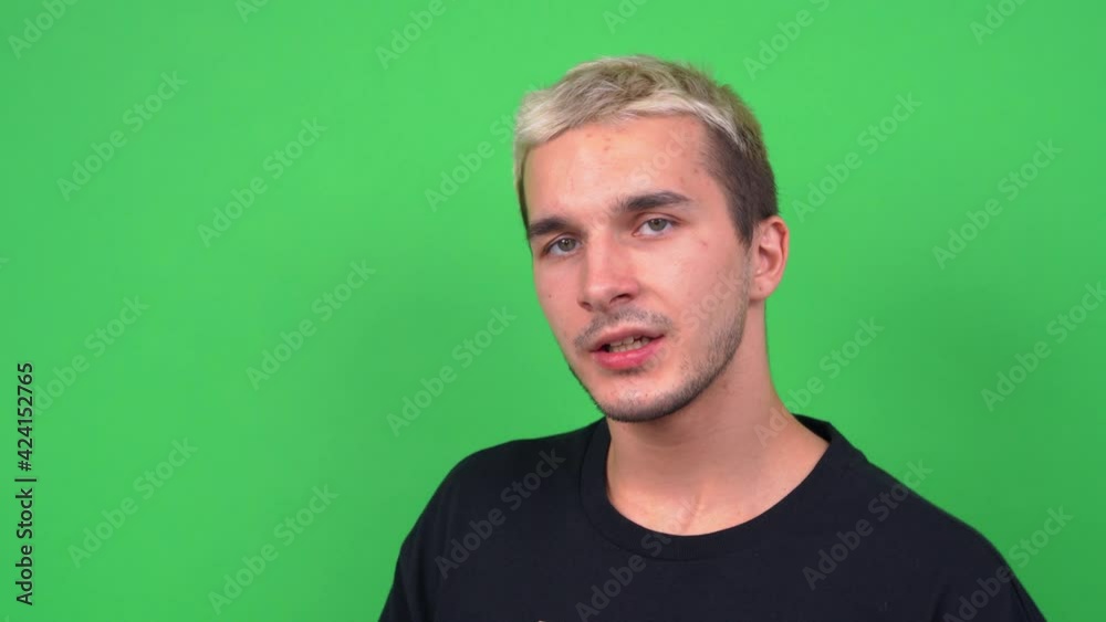 Expressive performance of young singer at casting for musical TV show, chromakey. Young guy with troubled teenage facial skin sensually recites poetry. Expressive performance of young singer at casting for musical TV show, chromakey. Young guy with troubled teenage facial skin sensually recites poetry.