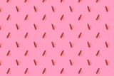 . Leaf shaped pink chocolate, chocolate confectionery sprinkles sprinkled on the background. pattern
