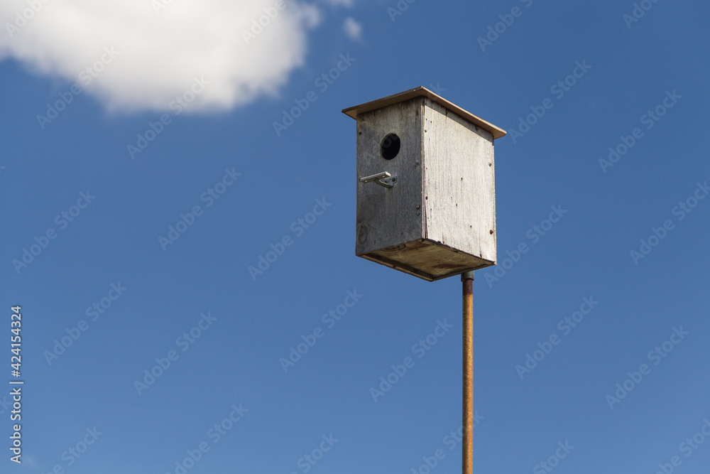 Wooden birdhouse against the sky, do-it-yourself birdhouse, house for birds