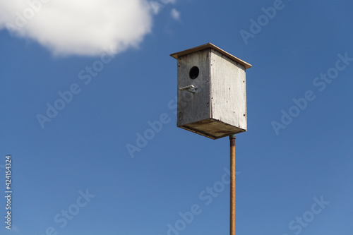 Wooden birdhouse against the sky, do-it-yourself birdhouse, house for birds