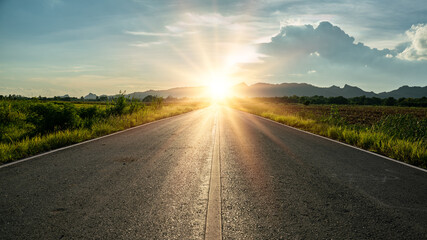 Blurry of road in the middle of asphalt road at sunset.Concept of planning and challenge or career path,business strategy,opportunity and change.New year or start straight concept.