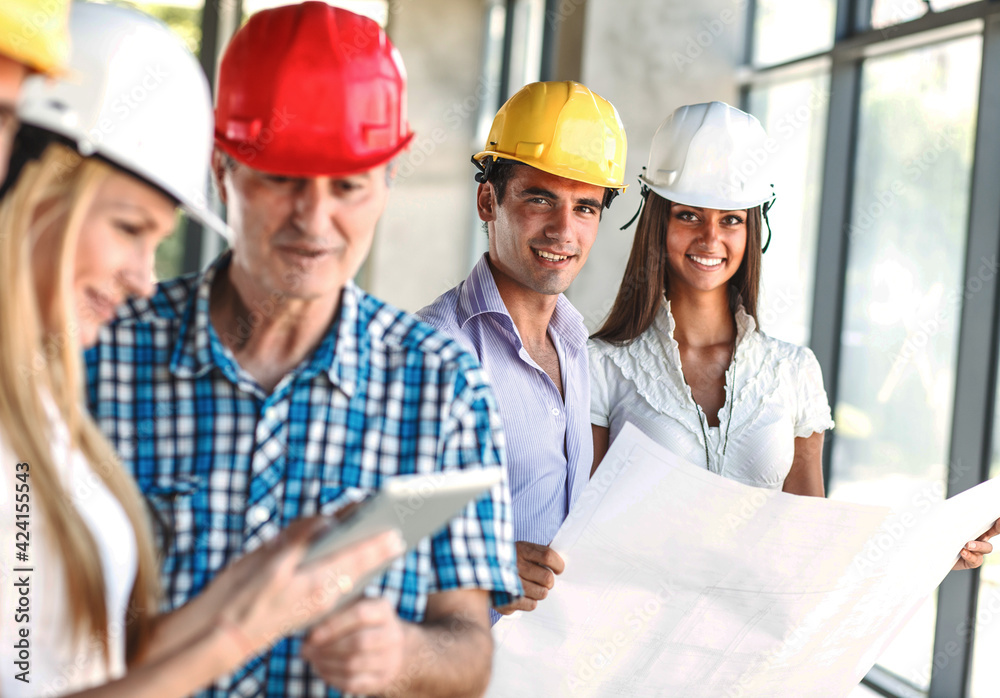 Two architects and engineers looking and discuss with about blueprint and construction project. Two architects and engineers looking and discuss with about blueprint and construction project.