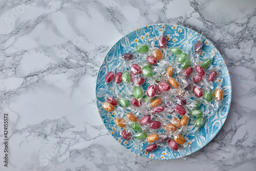 colorful candies in plate on a kitchen table