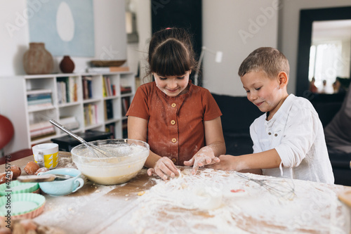 mother with her kids baking together at home
