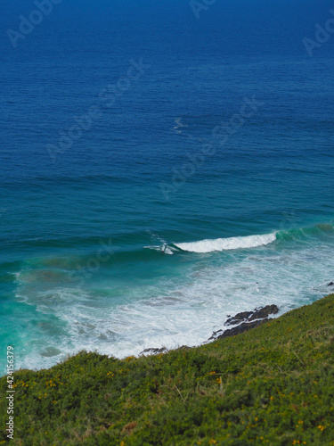 A bodyboarder surfs the waves in the rocket coast with the blue sea in the background. photo