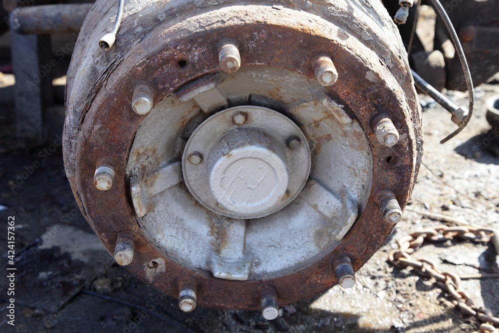 Dirty heavy truck drum brakes maintenance, old used brake drum with wheel pins closeup Dirty heavy truck drum brakes maintenance, old used brake drum with wheel pins closeup