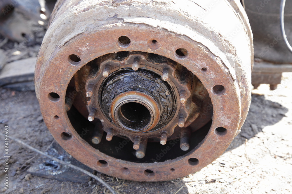 Dirty heavy truck drum brakes service, disassembled old used brake drum and hub bearing with wheel nuts closeup Dirty heavy truck drum brakes service, disassembled old used brake drum and hub bearing with wheel nuts closeup