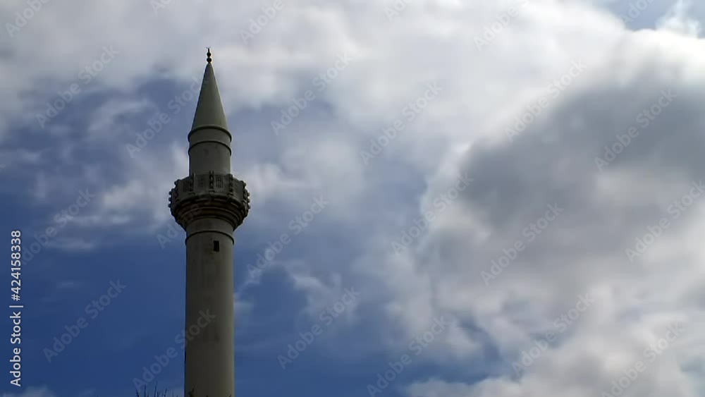 The minaret of an Islamic mosque with clouds in time-lapse Rhodes Greece The minaret of an Islamic mosque with clouds in time-lapse Rhodes Greece