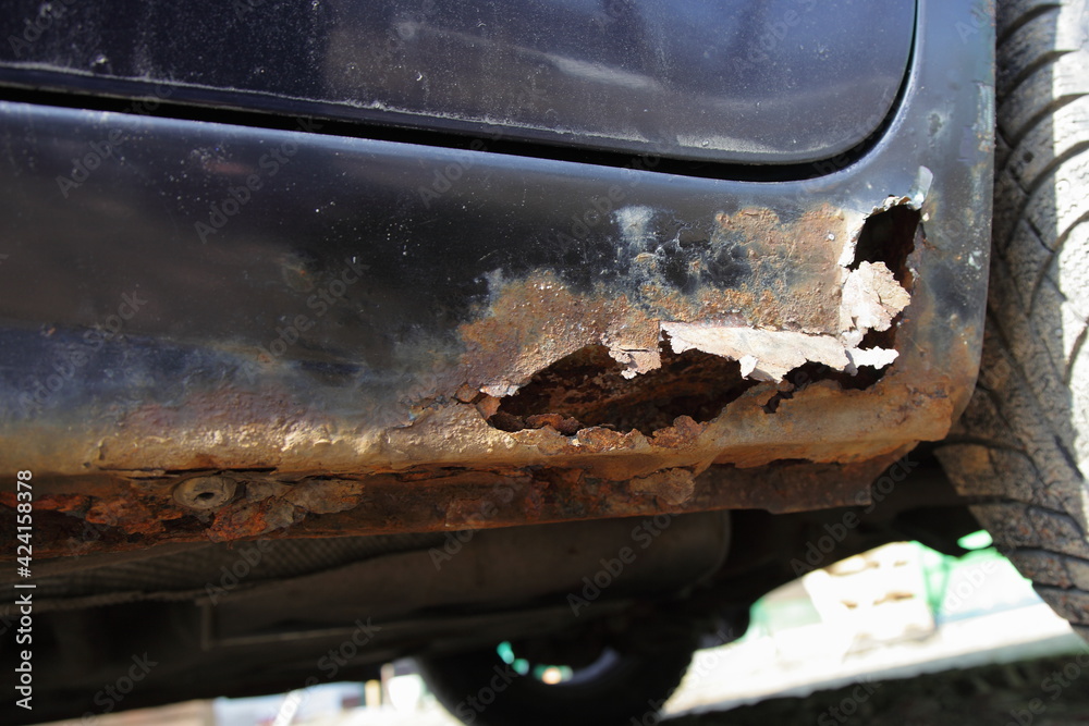 Through corrosion of the car door sill closeup, rust hole in vehicle