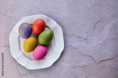 colored Easter eggs in a white plate