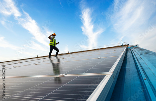 Male Engineer Inspects Solar Panels on Hospital Building Roofs, Solar Panel Maintenance Inspector