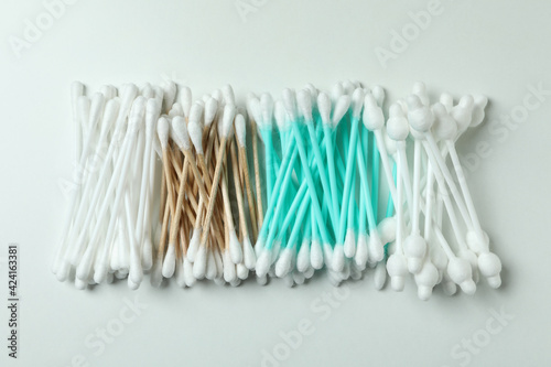 Different cotton swabs on white background  top view