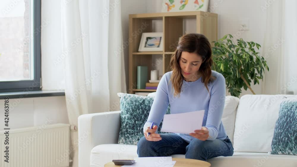 accounting, taxes and finances concept - young woman with papers and calculator at home accounting, taxes and finances concept - young woman with papers and calculator at home