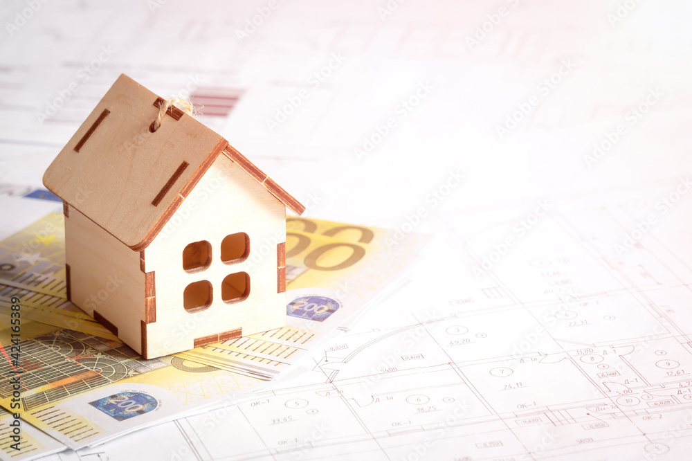 Wooden house, paper money, euro, on the background of the architectural plan of the building of the house. Close-up, selective focus. The concept of financial costs for construction Wooden house, paper money, euro, on the background of the architectural plan of the building of the house. Close-up, selective focus. The concept of financial costs for construction