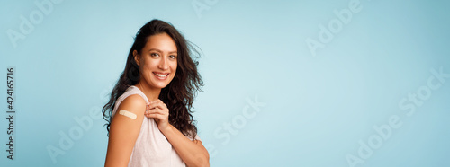 Canvas Print Vaccinated Woman Showing Arm After Covid-19 Vaccine Injection, Blue Background