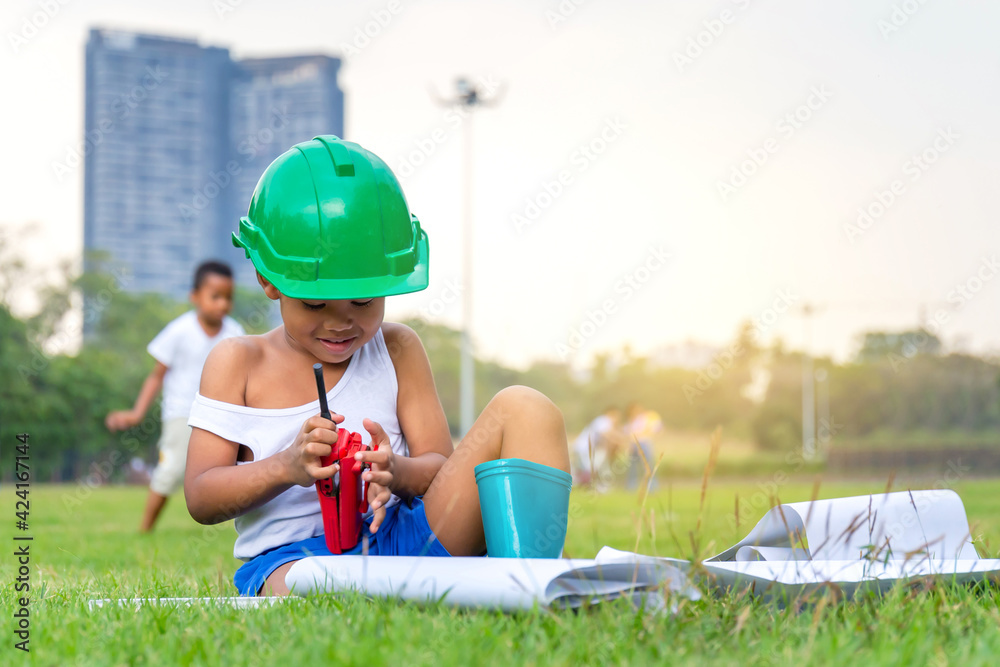 Portrait of happy african american kids boy playing outdoors in a park, Kid playing construction worker concepts Portrait of happy african american kids boy playing outdoors in a park, Kid playing construction worker concepts
