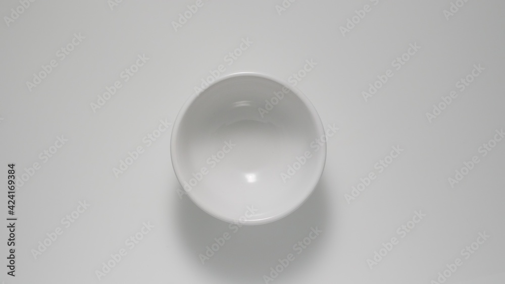 TOP VIEW: Empty small white dish on a table