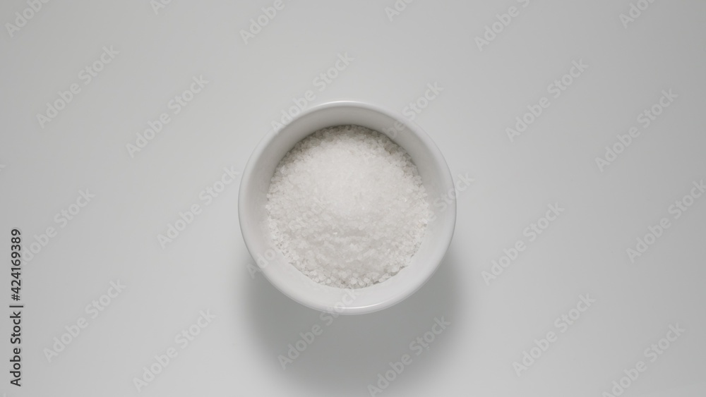 Salt in white dish on a table, Top view Salt in white dish on a table, Top view