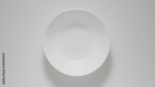 TOP VIEW: Empty white dish on a table