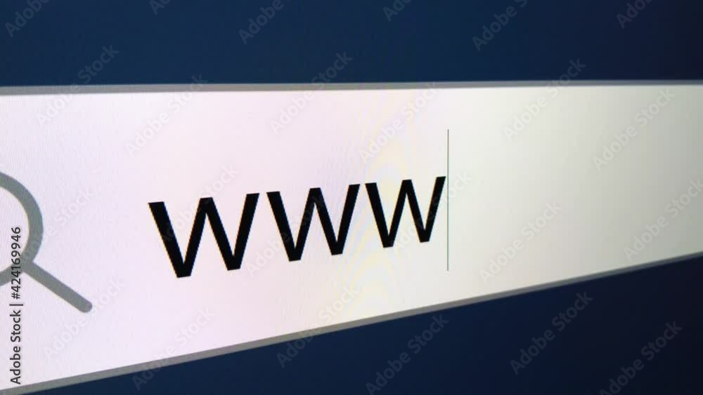 WWW written in search bar with cursor, computer monitor, close-up with camera zoom effect