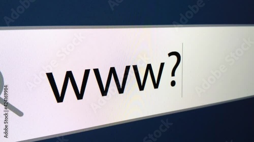 WWW at the end a question mark is written in the search bar with a cursor, a computer monitor, close-up with the effect of a camera zoom