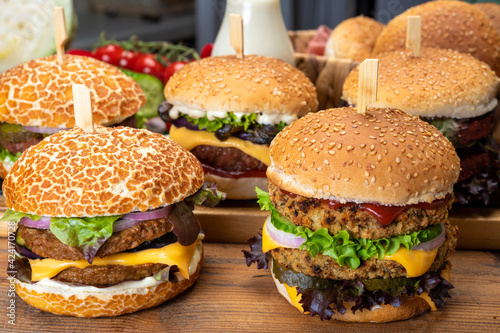Tasty vegetarian cheeseburgers and hamburgers with round patties or burgers made from grains  vegetables and legumes