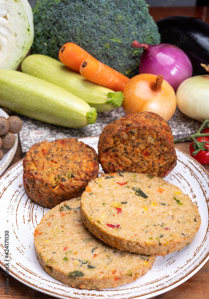 Round vegetarian patties or burgers made from grains, vegetables and legumes Round vegetarian patties or burgers made from grains, vegetables and legumes