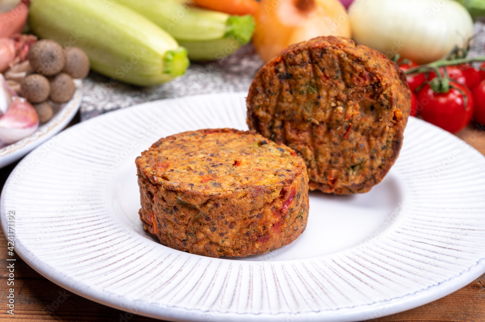 Round vegetarian patties or burgers made from grains, vegetables and legumes Round vegetarian patties or burgers made from grains, vegetables and legumes