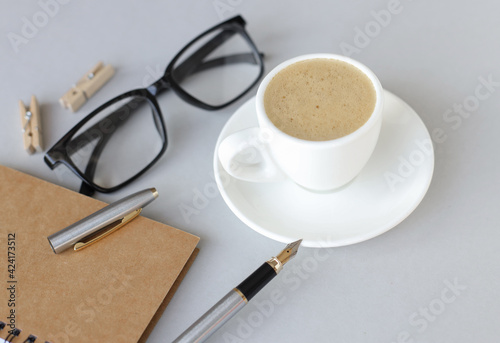 Cup of coffee with on gray background, top view, copy space