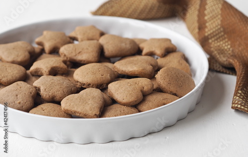Creamy honey cookies with cocoa in a white dish. Homemade natural pastries for a holiday or every day.