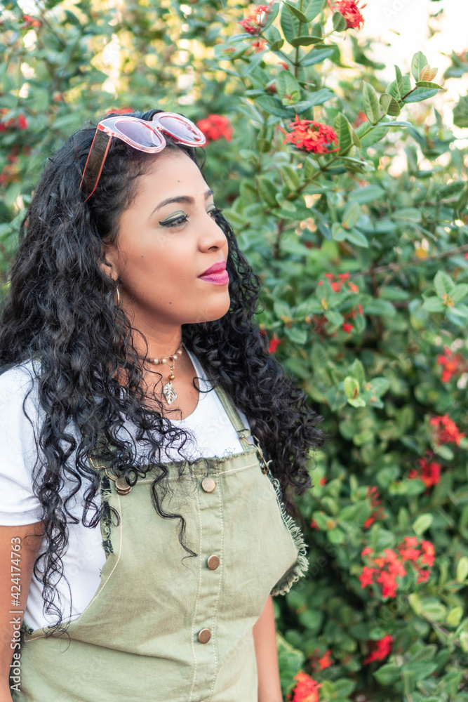 Woman with curly hair standing in the city. Woman with curly hair standing in the city.