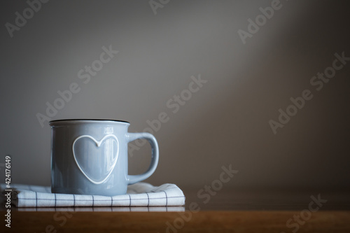 mug with heart on towel on the kitchen table.father's day with love. dark background