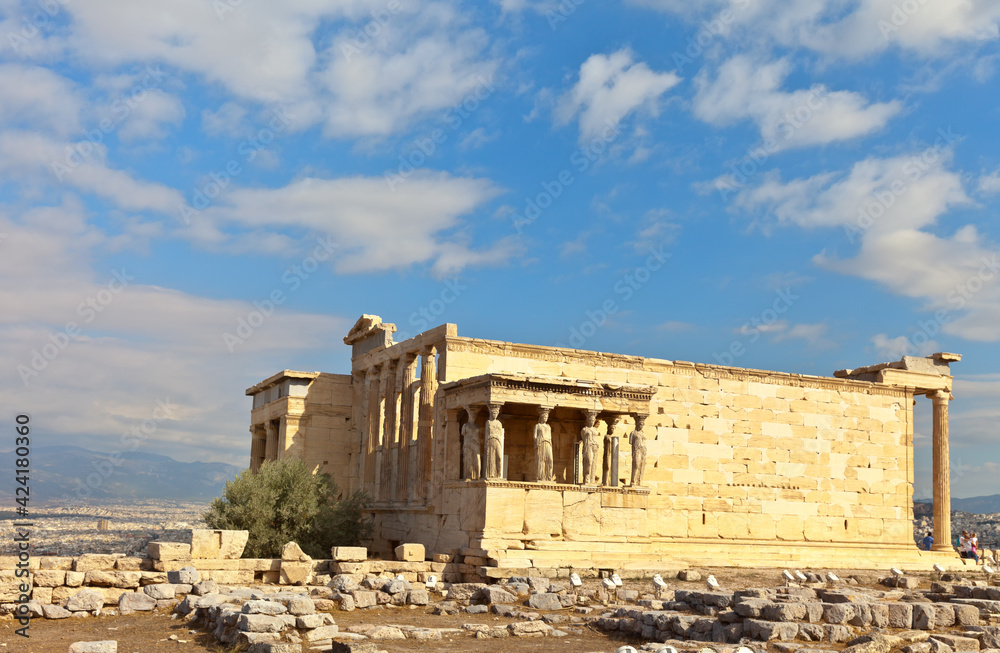 Greece. General view of the restored temple of the Erechtheion in the ancient Athenian Acropolis (421-406 BC) against the background of a blue sky with clouds. Travel, excursions and sightseeing 
