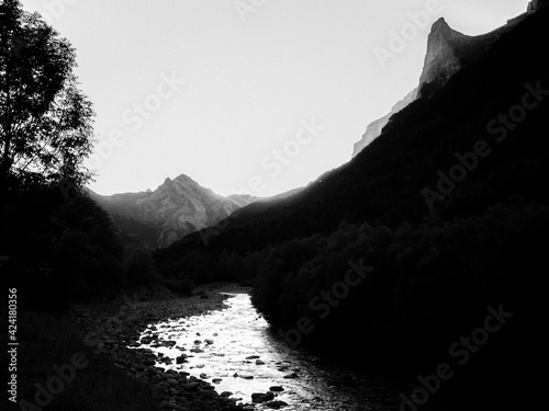 Imagen en blanco y negro infrarrojo digital de la puesta de sol sobre los picos, bosques y riachuelos del Parque Nacional de Ordesa, en los Pirineos españoles photo