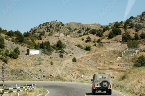 Military Russian car passing on the road in disputed territory of Nagorno Karabakh photo