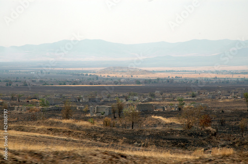 Deserted landscape with bombed houses in Nagorno Karabakh photo