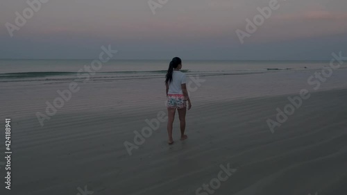 sunrise on the beach with palm trees, Chumphon Thailand, couple watching sunset on the beach in Thailand Asia, mean and woman mid age watching sunrise on beach photo