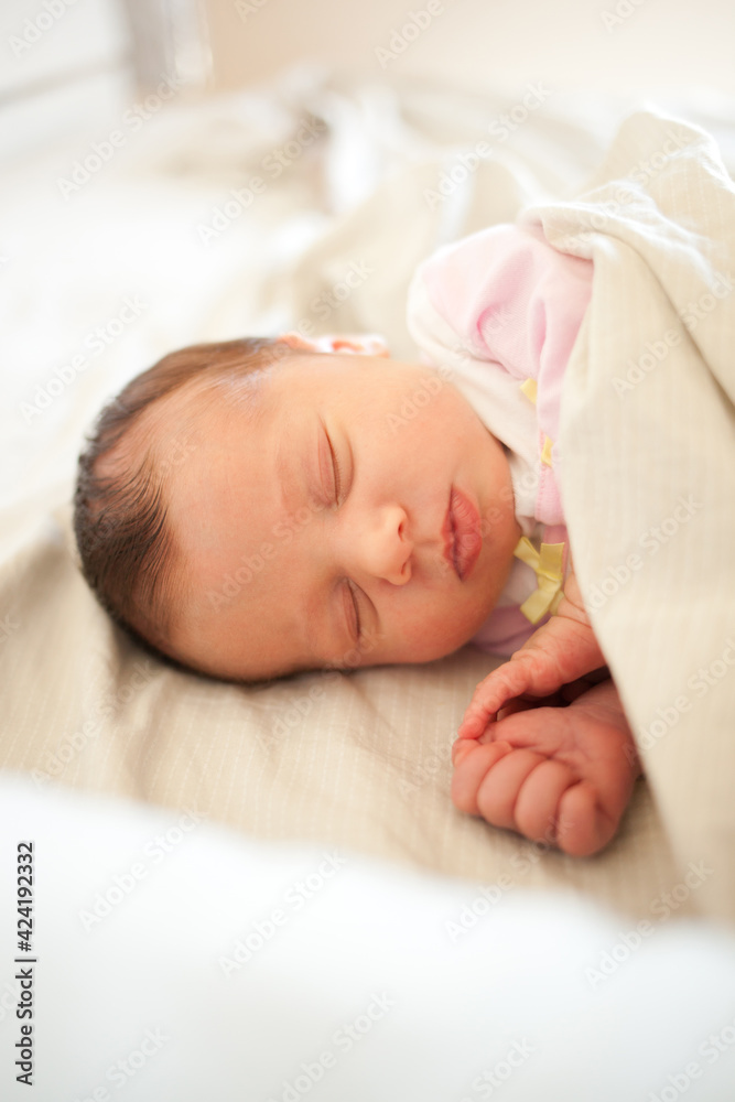 Newborn baby girl sleeping in bed. Newborn baby girl sleeping in bed.