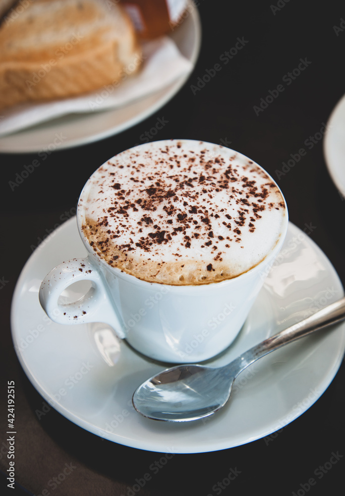 Hot mocha coffee with milk foam and cocoa powder.
