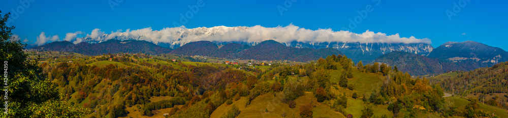 Outstanding panorama view of Piatra Craiului Mountains from Moieciu Village in an autumn day