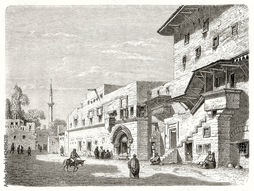 medieval stone buildings fronting a court where life s going on in Street of the Jews. Ancient grey tone etching style art by Trichon  Le Tour du Monde  1862