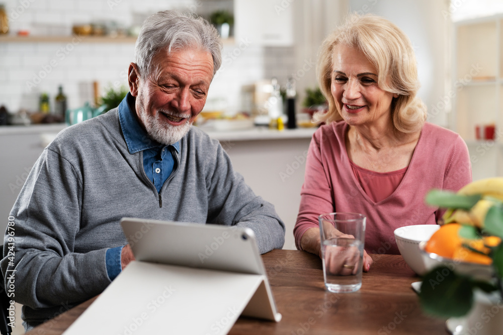 Senior couple having video call. Happy husband and wife talking with their grandkids. Senior couple having video call. Happy husband and wife talking with their grandkids.