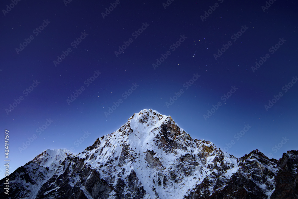 Starry night sky and snow mountains in Himalayas, Nepal Starry night sky and snow mountains in Himalayas, Nepal