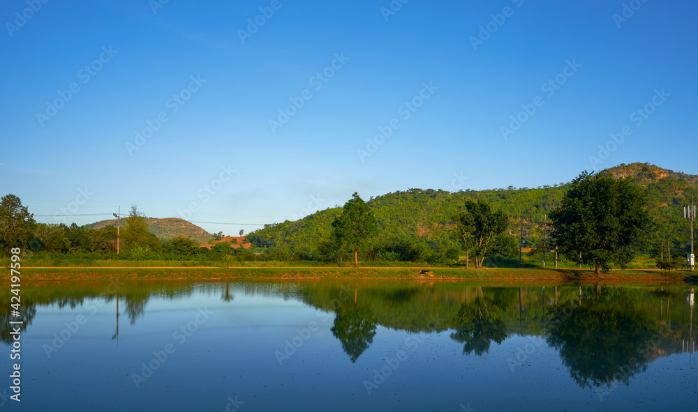 Landscape of countryside mountain and tree with mirror on water