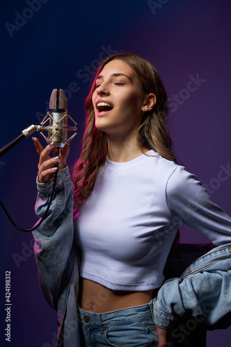 Young Caucasian girl singing enjoying with closed eyes photo