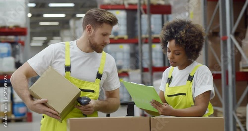 Diverse colleagues doing inventory in warehouse scanning barcode photo