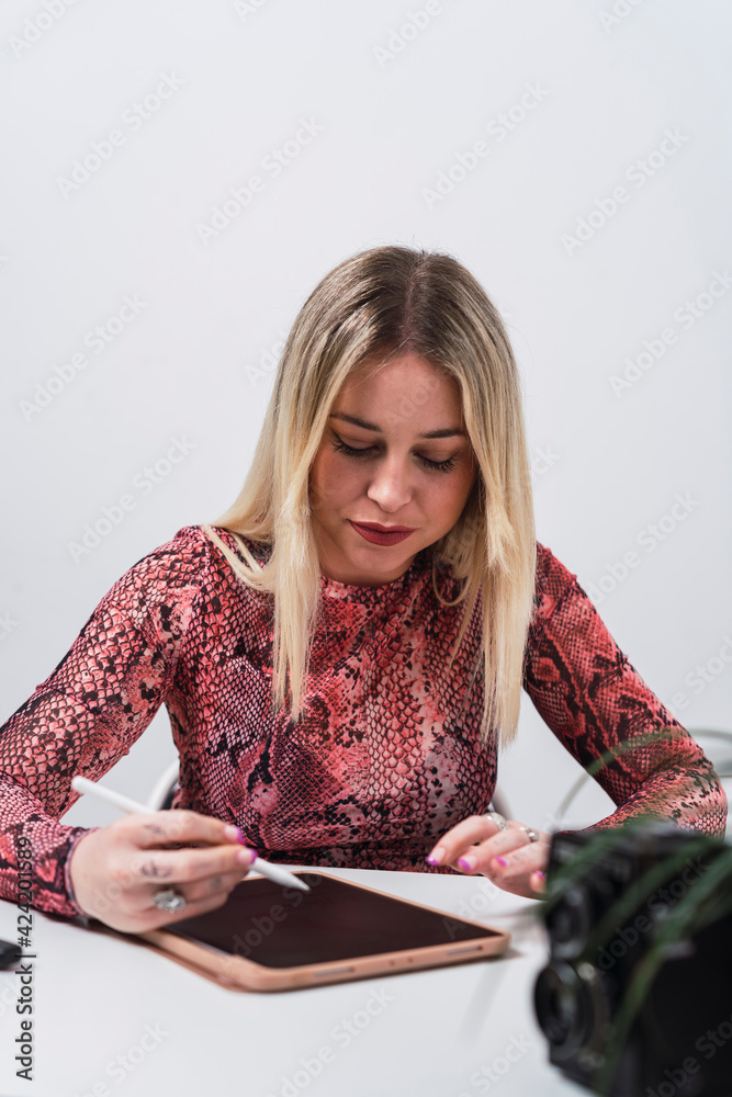Spanish female working with a tablet at desk Spanish female working with a tablet at desk