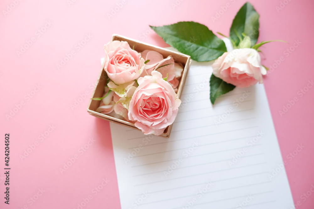 Spring greeting concept. Pink roses gift box with blank letter papers on pink background. Wedding, Bridal, Mother's day and Birthday. ピンク薔薇とカード、結婚式、母の日、誕生日のデコレーション背景